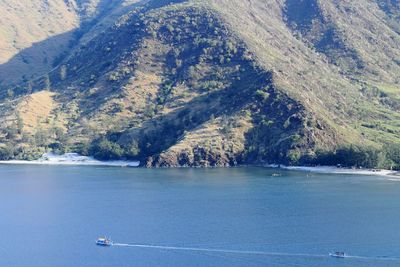 Scenic view of sea by mountain