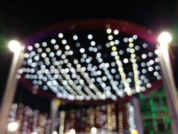 Low angle view of illuminated lights at night