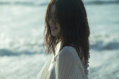 Portrait of woman looking at sea