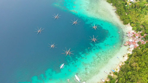 Aerial drone of village of fishermen with houses and fishing boats. samal island, mindanao.