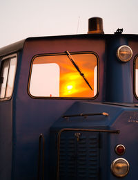 Close-up of yellow car against sky