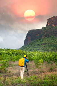 Rear view of man against orange mountain