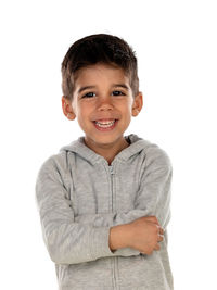 Portrait of smiling boy standing against white background