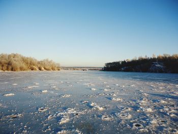 Scenic view of snow covered field against clear sky