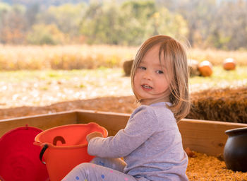 Portrait of smiling girl sitting outdoors