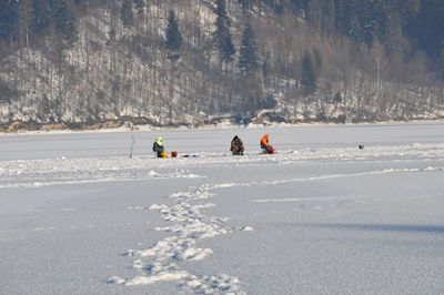 People walking on snow covered land