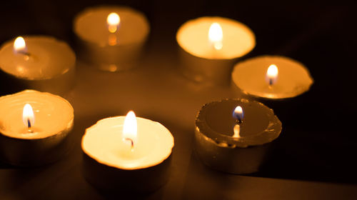 Close-up of lit candles on table