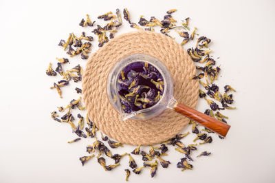 High angle view of dried flower on table against white background