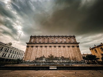 Low angle view of historic building against cloudy sky