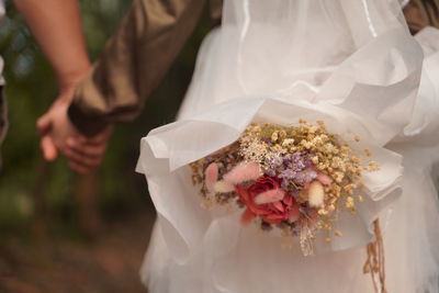 Midsection of couple during wedding ceremony