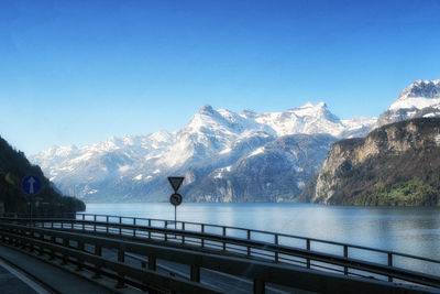 Scenic view of snowcapped mountains against blue sky