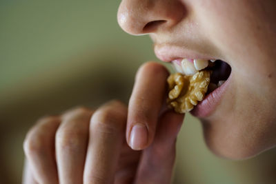 Cropped hand of woman eating food