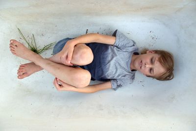 High angle view of boy lying on floor