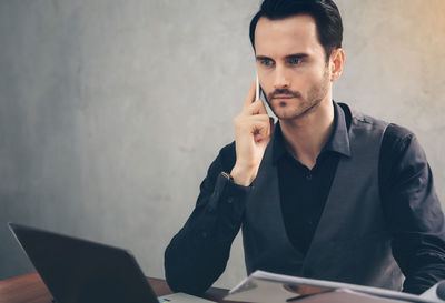 Portrait of young man using mobile phone