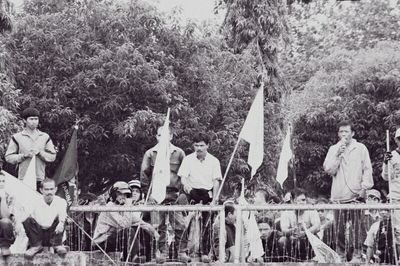 Group of people sitting by trees