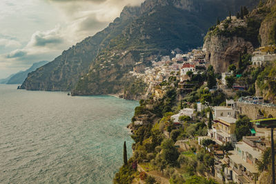 Panoramic shot of townscape by sea against sky