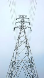 Low angle view of electricity pylon against clear sky