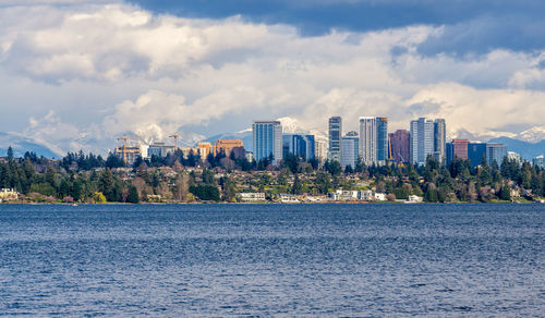 Modern buildings in bellevue, washington with the cascades range in the background.