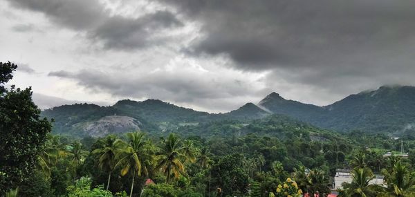 Scenic view of mountains against cloudy sky