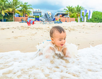 Cute boy on sand at beach