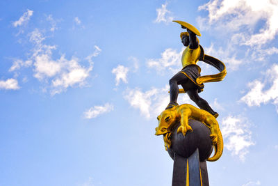 Low angle view of statue against blue sky