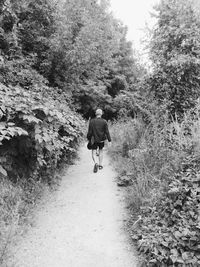 Full length of woman walking on dirt road