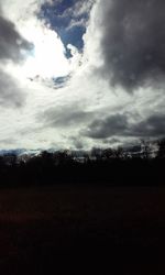 Silhouette trees on landscape against sky