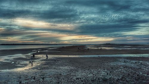 View of beach against cloudy sky