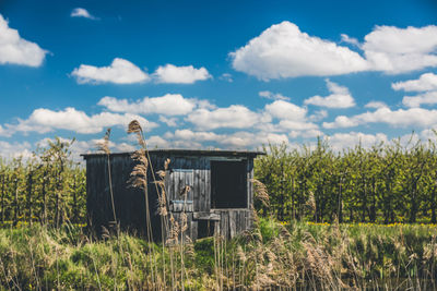 Abandoned built structure on field against sky