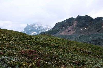 Scenic view of mountains against cloudy sky