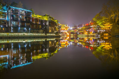 Reflection of illuminated buildings in water at night