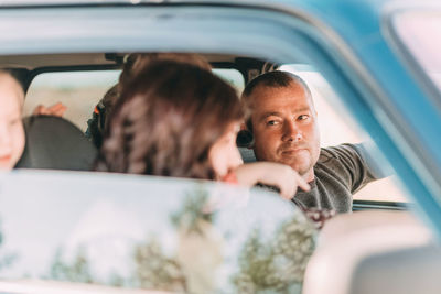 Happy family ride in car, man driving car . buying and renting a car. travel, tourism, recreation.