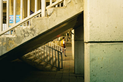 Man walking on staircase of building