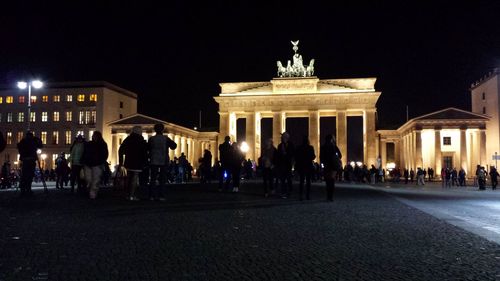 Statue in city at night