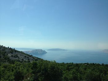 Scenic view of landscape and sea against sky