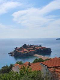 High angle view of sea and buildings against sky