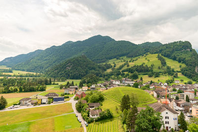 Balzers, liechtenstein, june 5, 2022 view over the alpine area and the small town on a cloudy day