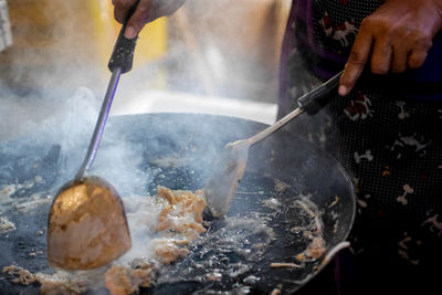 Midsection of people preparing food