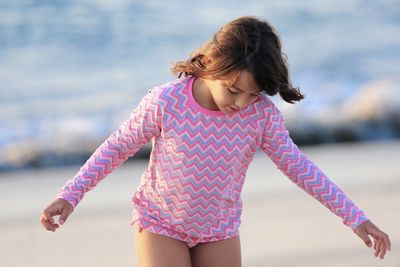 Front view of girl in pink at beach