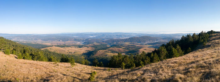 Scenic view of mountains against clear blue sky