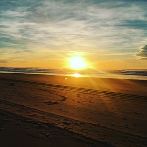 Scenic view of beach against sky during sunset