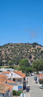 View of townscape against clear blue sky