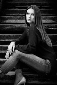 Portrait of young woman sitting outdoors