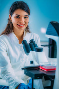 Biology student researcher looking through the microscope