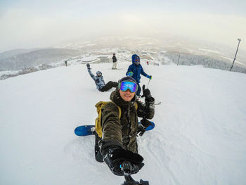 High angle view of people on snow covered mountain