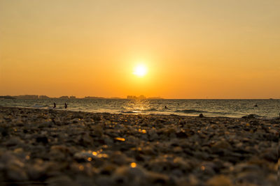 Scenic view of beach against sky during sunset