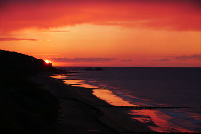 Scenic view of sea against romantic sky at sunset