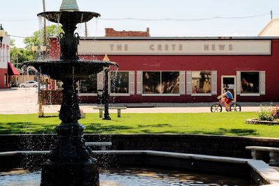 Water fountain in park against sky