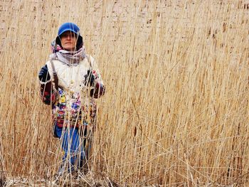 Portrait of boy standing in field