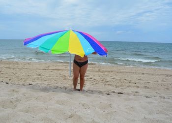 Woman with umbrella on beach